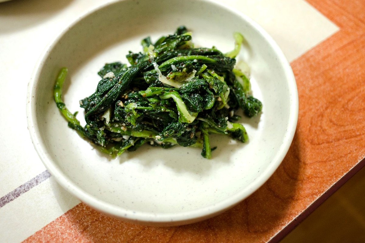 白い器に盛られた青菜のおひたし。明るい食卓に置かれた、食物繊維を添える一品
