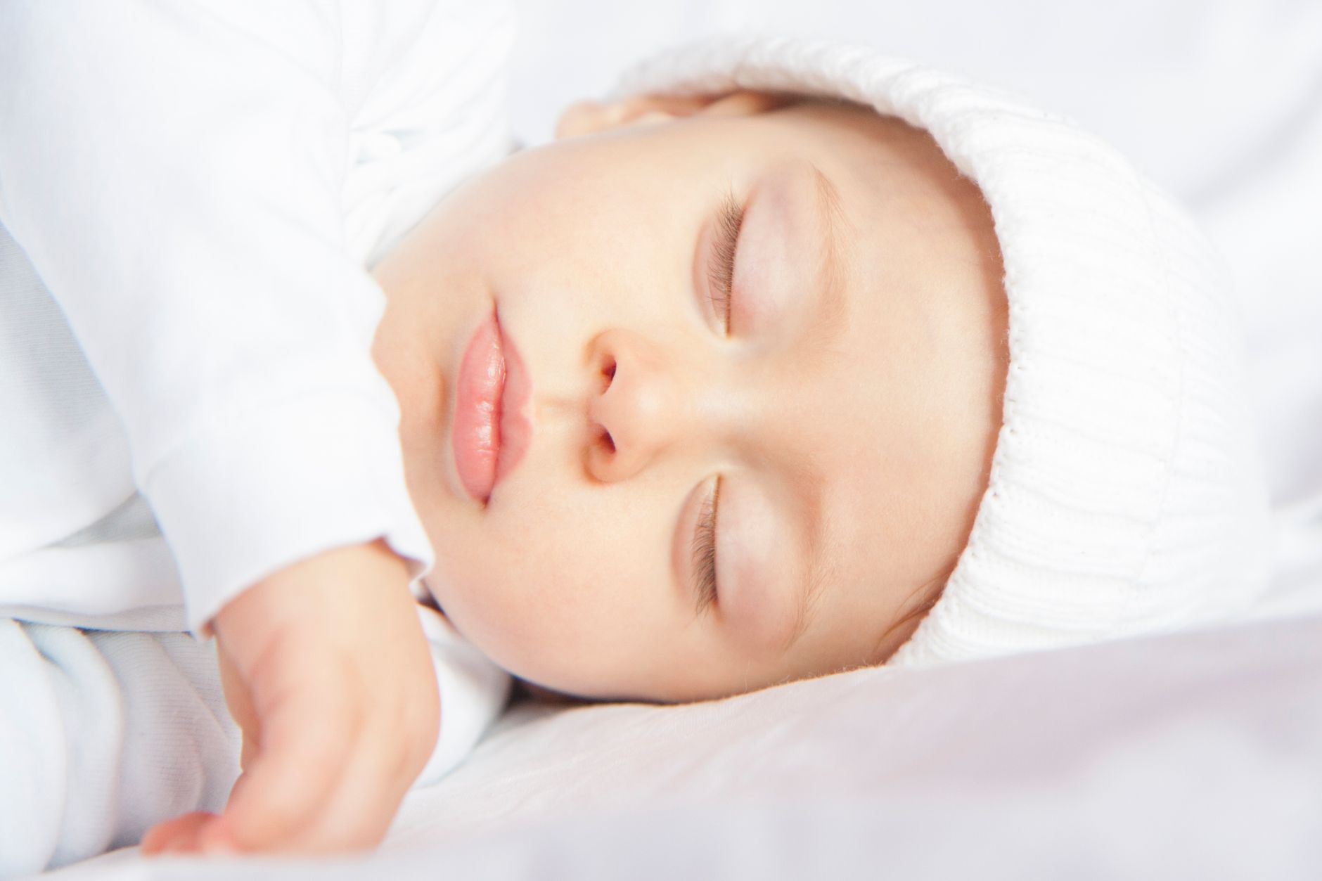 A very young baby sleeping peacefully at home