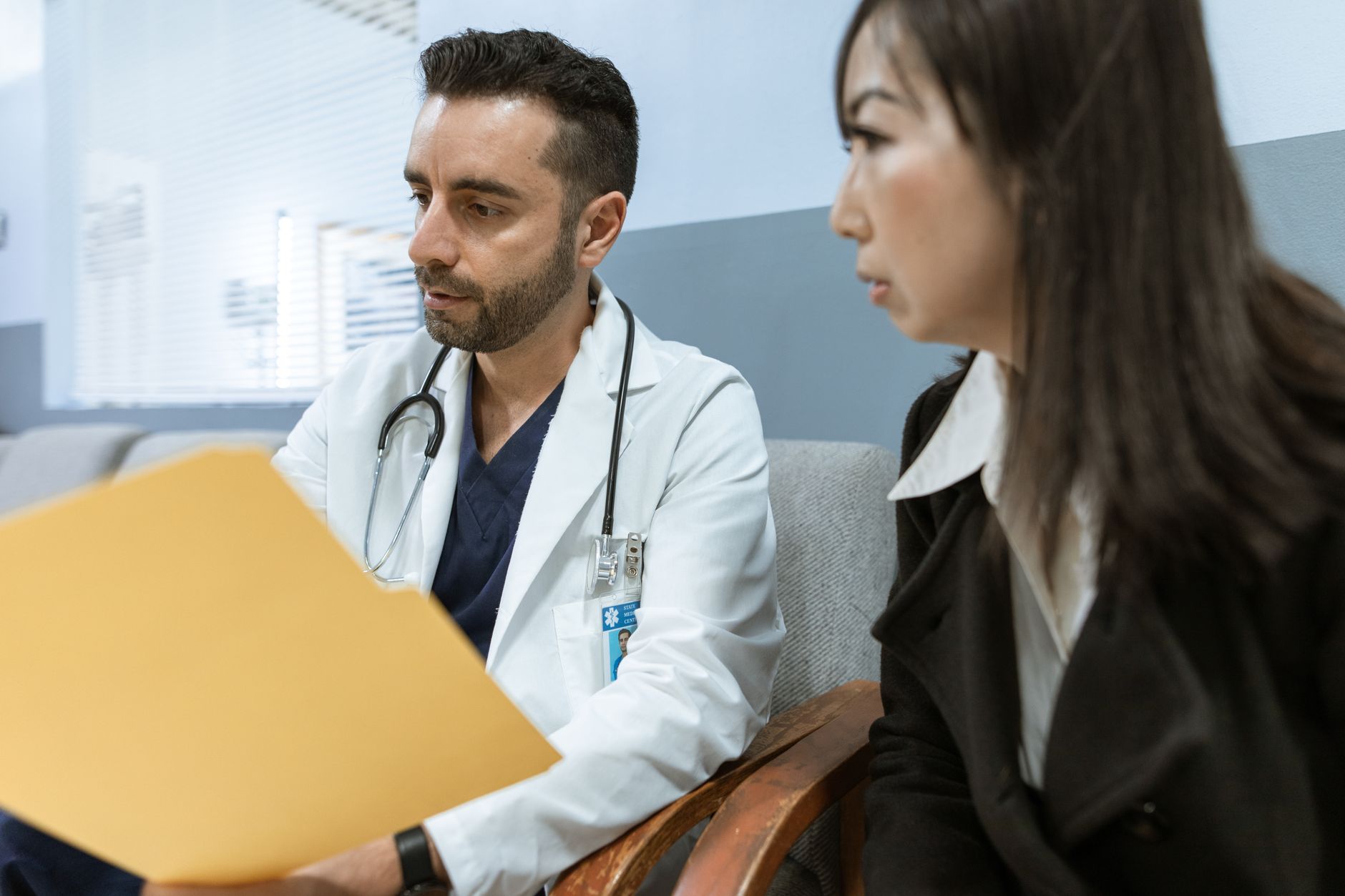 A man talking with a doctor in a bright clinic